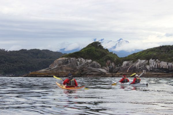 Kayakers paddling amongst rocks in Chile