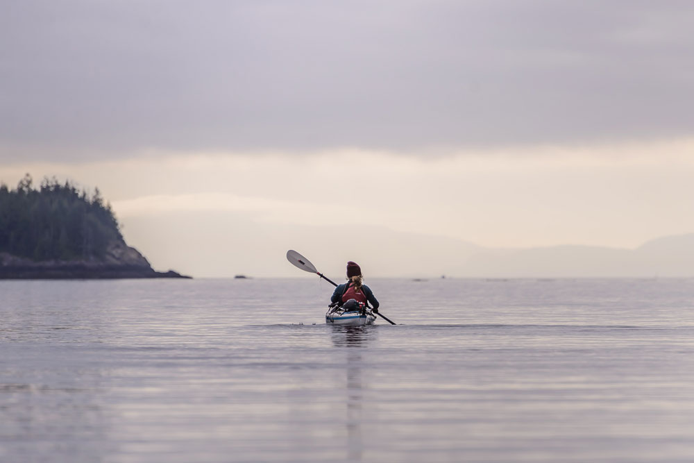 Lone sea kayaker paddling in the ocean