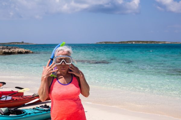 Snorkeler posing on a beach in the Bahamas