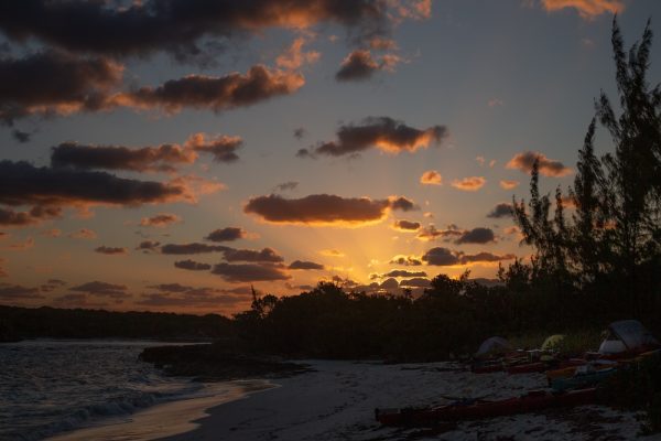 Sunset over a beach of tents in the Bahamas